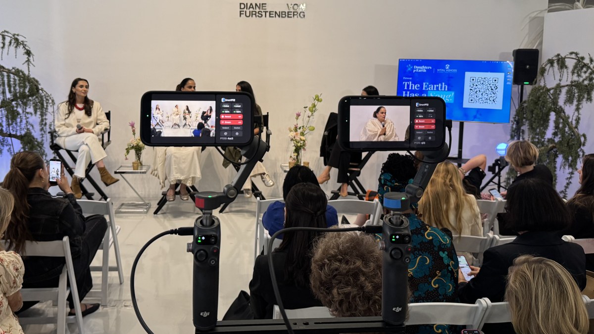 Four iPhones on gimbals covering a live panel
